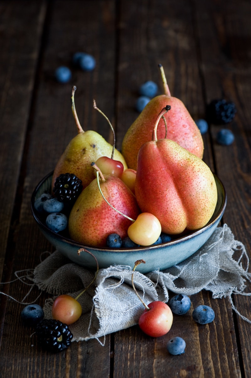 Bowl of Pears, Blueberries, Blackberries, and Cherries on Wood