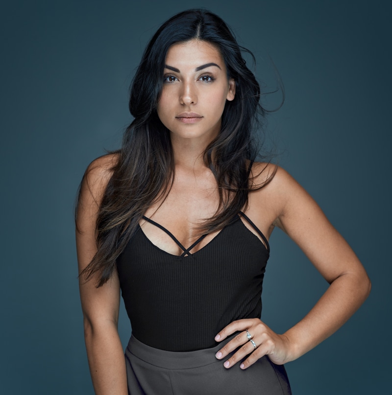 Brunette woman with hands on hips