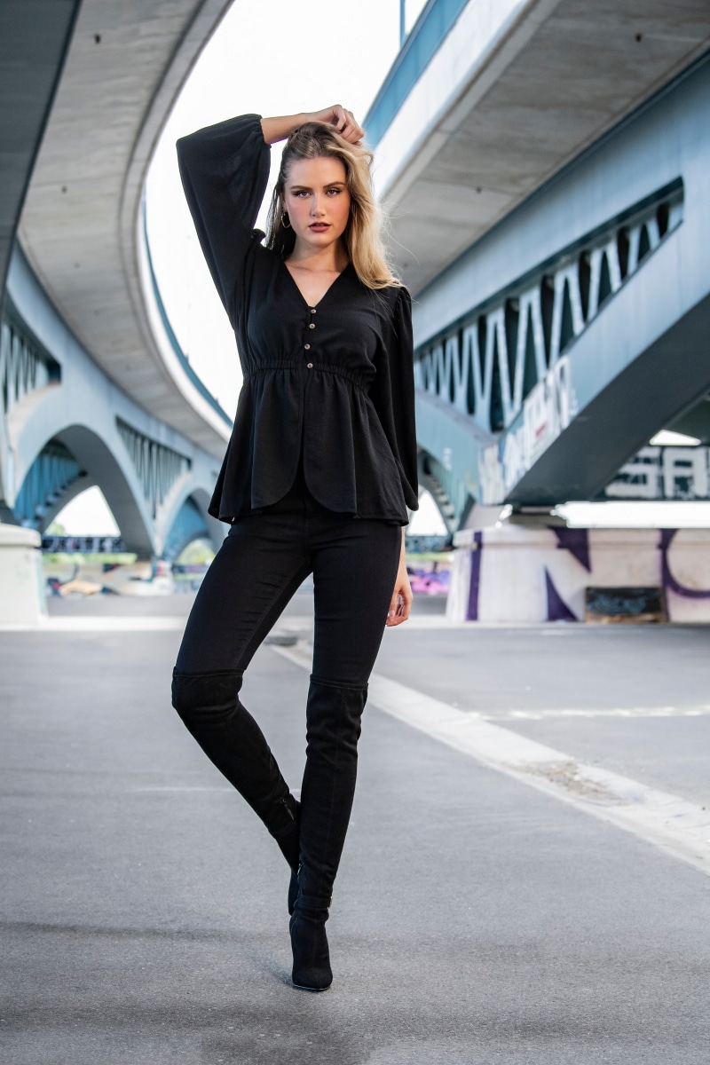 Jolanda posing under a bridge