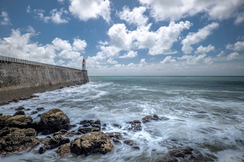 Lighthouse on a stone pier in Les Sables-d'Olonne, France
