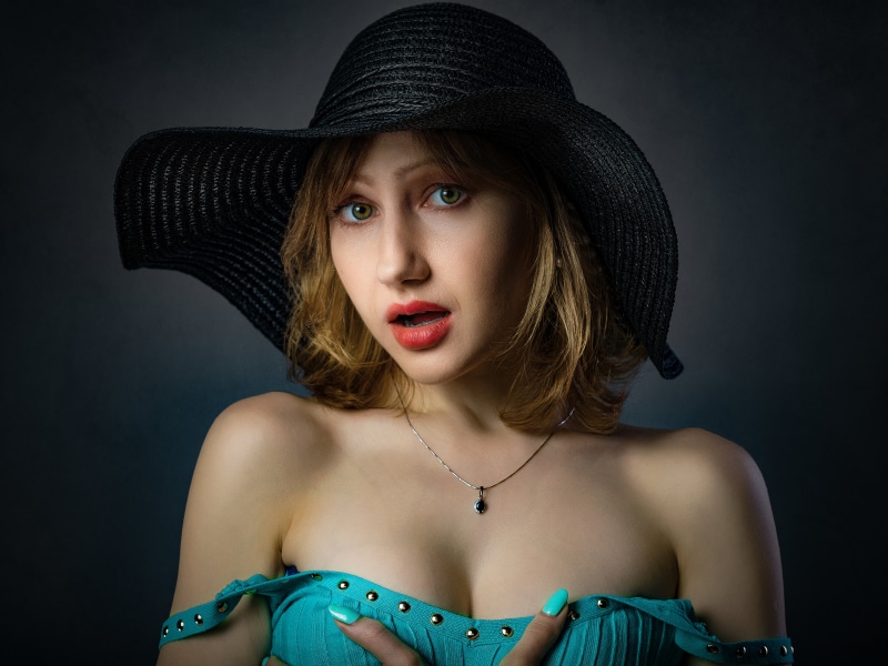 Woman in a black hat and blue dress