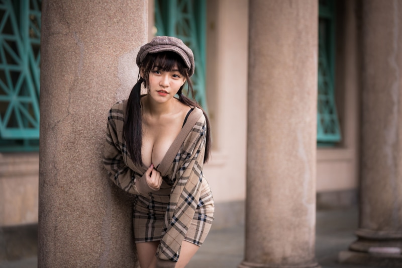 Asian woman in dress and baseball cap