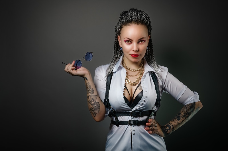 Woman with tattoos and glasses