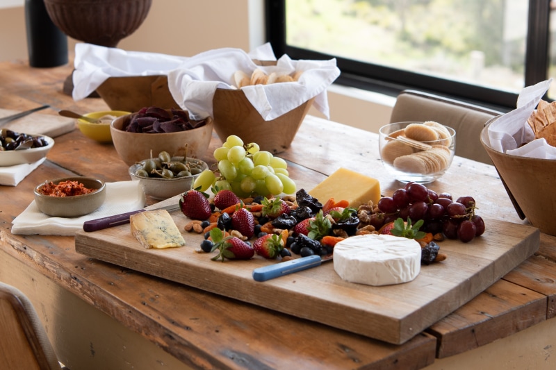 Cheese and fruit platter on a wooden table