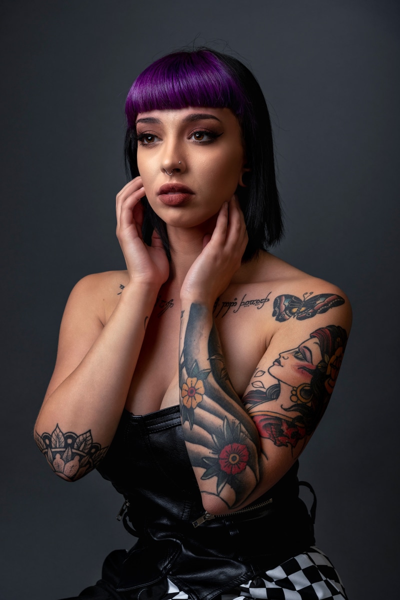 Woman with purple hair and tattoos
