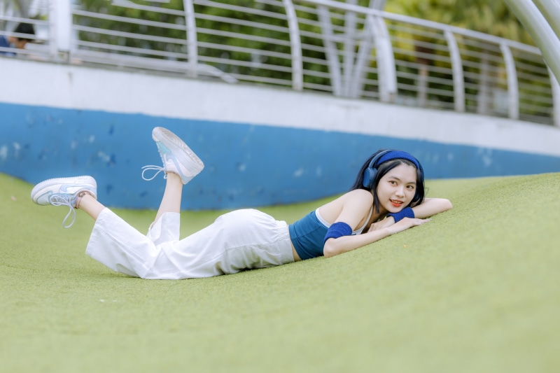 Brunette girl with headphones lying down