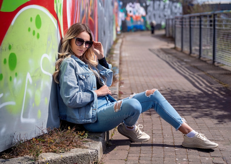 Woman in Denim Jacket and Ripped Jeans