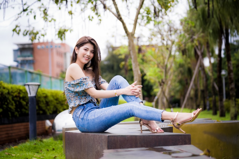 Asian woman sitting in a park