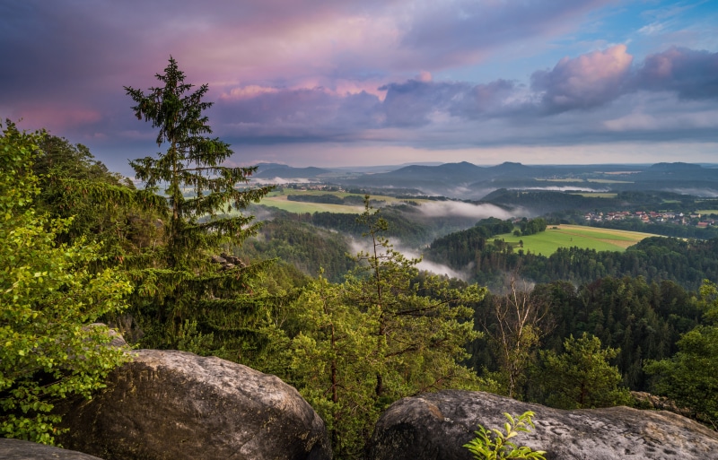 Misty valley landscape in Saxony, Germany at sunrise