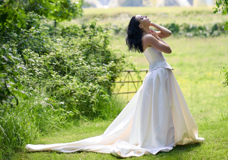 Woman in a wedding dress posing outdoors