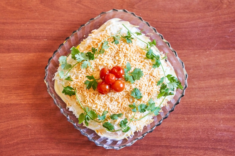 Salad with tomatoes and cheese in a glass dish