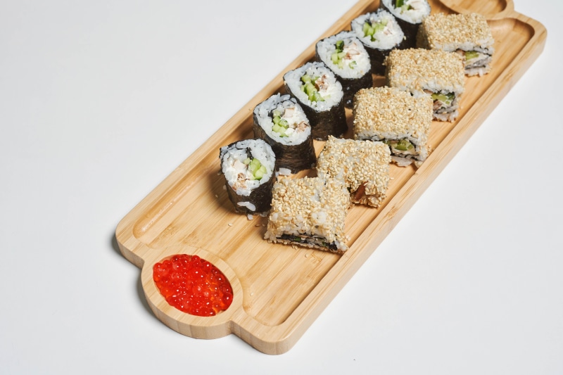 Sushi platter with caviar on a wooden board