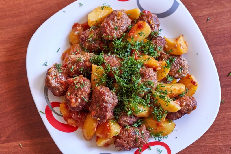 Meatballs and potatoes with dill on a plate