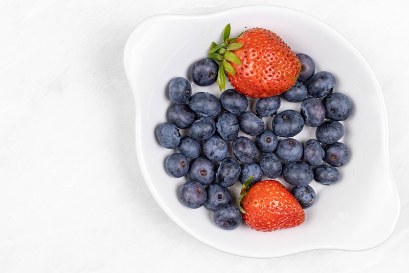 Blueberries and Strawberries in a White Plate
