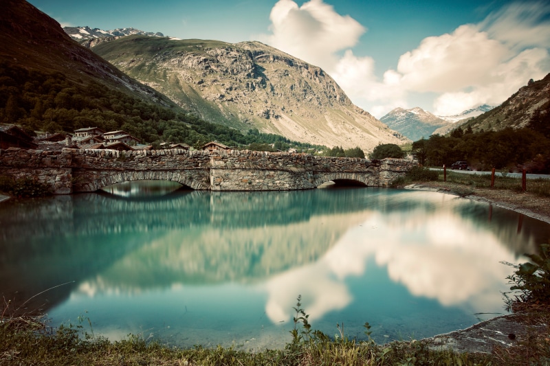 Stone bridge over a lake in Bonneval sur Arc, France