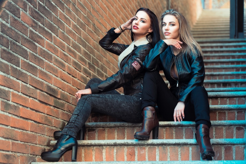 Anastasia Listratova and blonde woman sitting on stairs