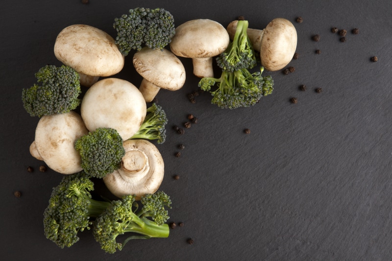Mushrooms, Broccoli, and Black Pepper on Gray Background