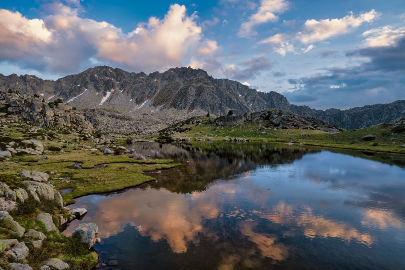 Mountains and lake with clouds reflection in Andorra