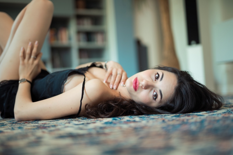 Brunette girl lying on a rug