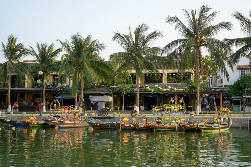 Hoi An, Vietnam river with boats and palm trees