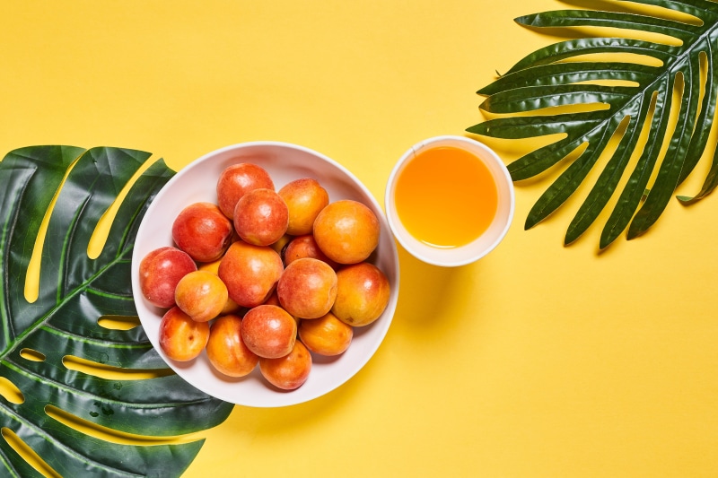 Apricots and Juice with Tropical Leaves