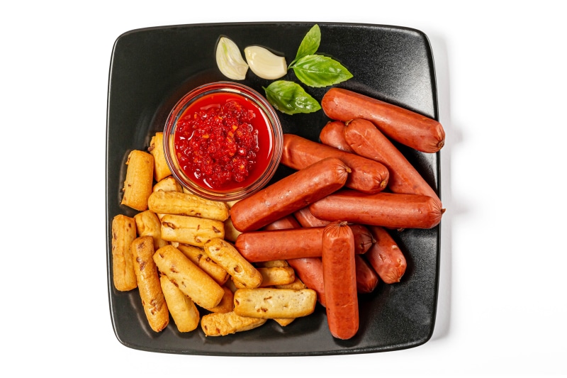 Vienna sausages with breadsticks and chili sauce