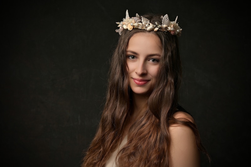 Woman with a seashell crown and long brown hair