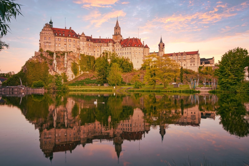 Sigmaringen Castle reflected in a lake at sunset