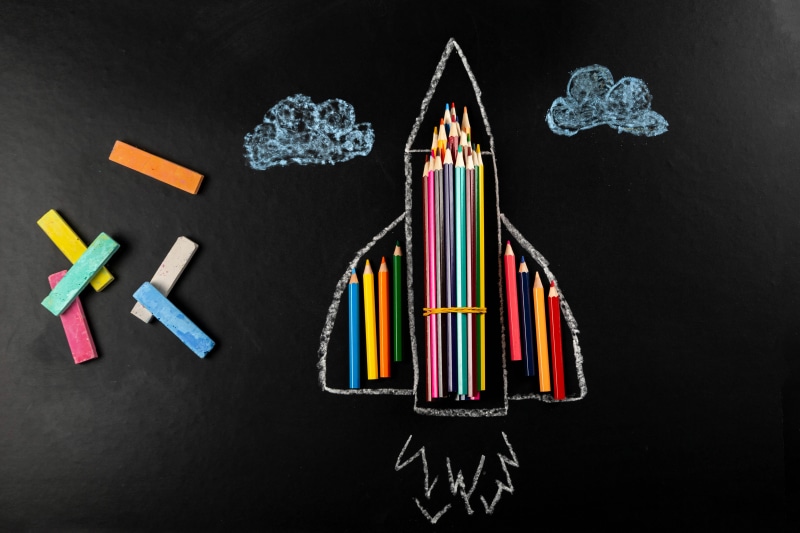Rocket made of pencils on a blackboard