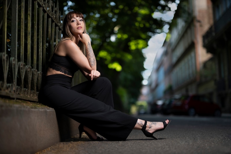 Woman sitting by a fence