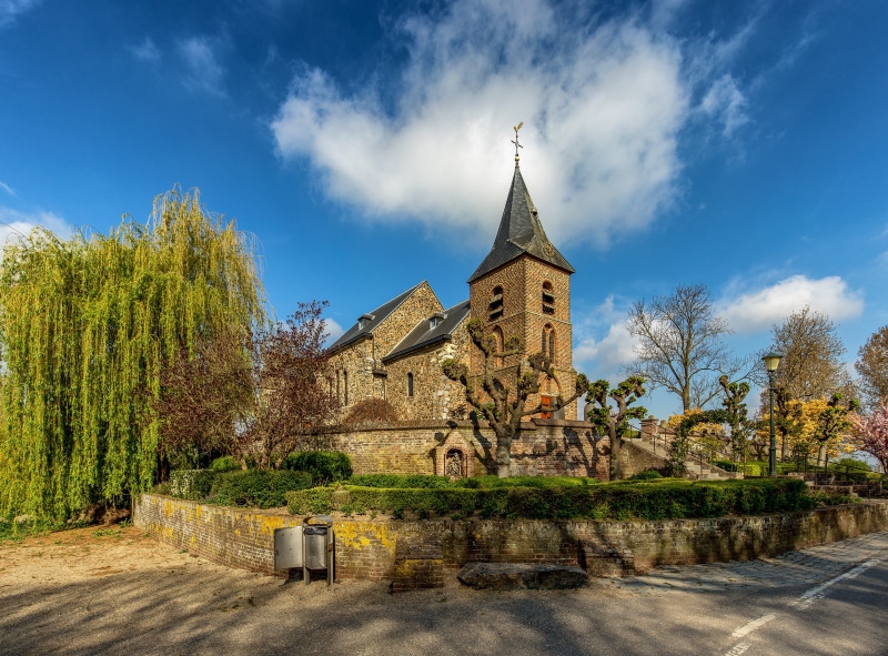 4K Church in Asselt, Netherlands with Trees and Clouds