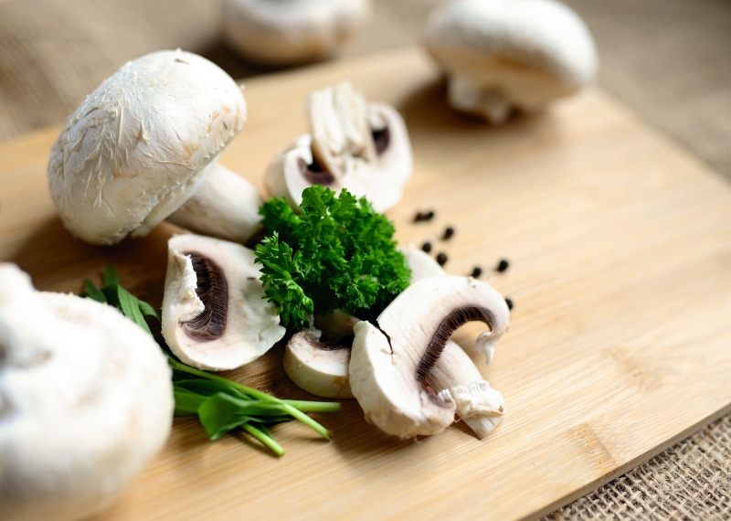 Mushrooms and herbs on a cutting board