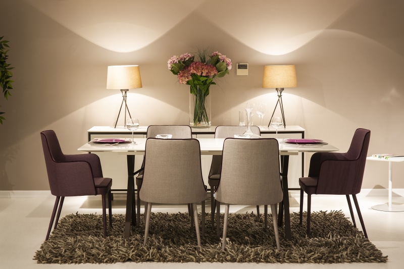 Dining table with chairs, lamps, and flowers