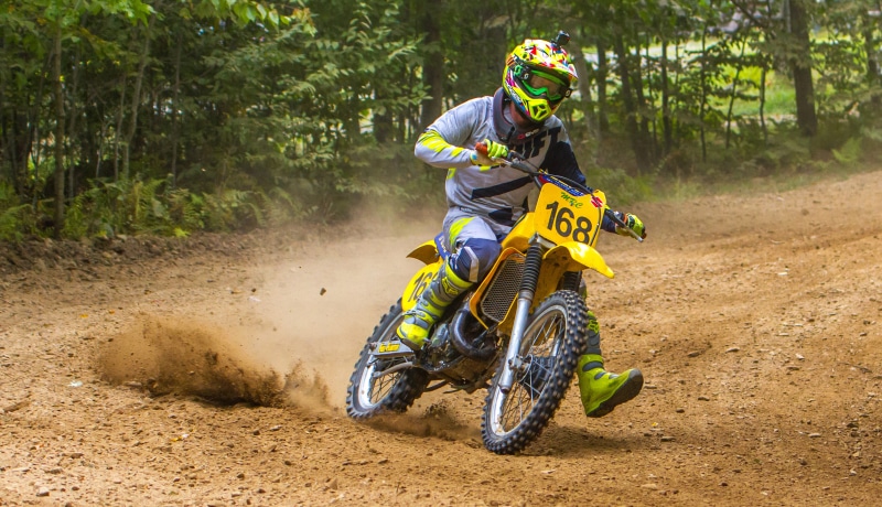 Motocross rider on a yellow Suzuki RM 125