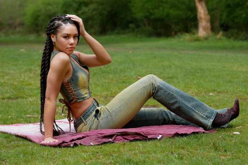 Monica Jasmine sitting on a blanket in a park