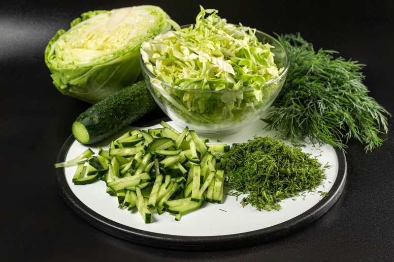 4K Cabbage, Cucumbers, and Dill on Cutting Board