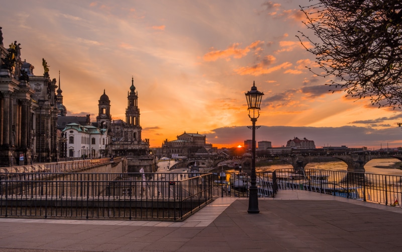 Dresden Germany riverfront at sunset with bridges and street lamp