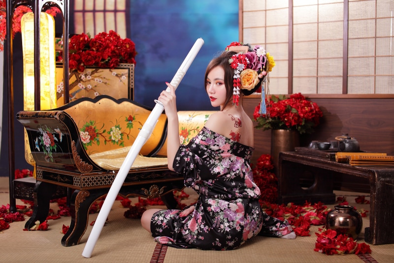 Asian woman in kimono holding a katana