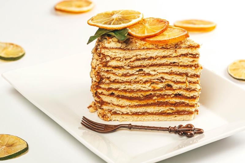 Slice of layered cake with dried orange slices