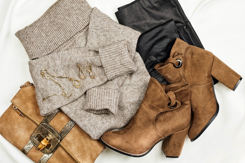 Fashionable outfit with sweater, boots, and accessories