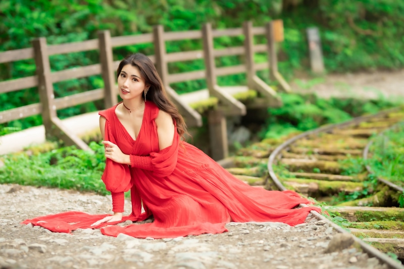 Asian Woman in Red Dress on Train Tracks