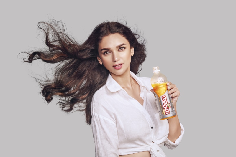Aditi Rao Hydari holding a Maaza bottle