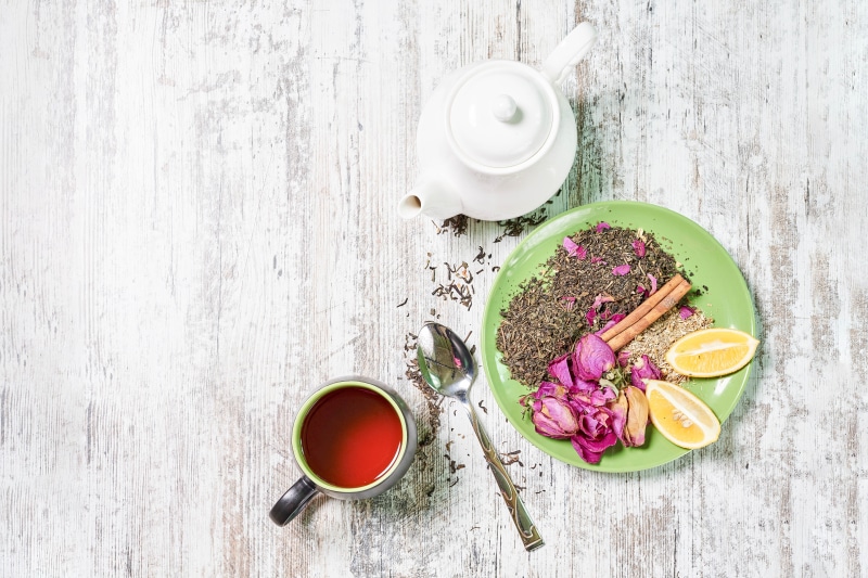 Tea set with dried roses, lemon, and cinnamon