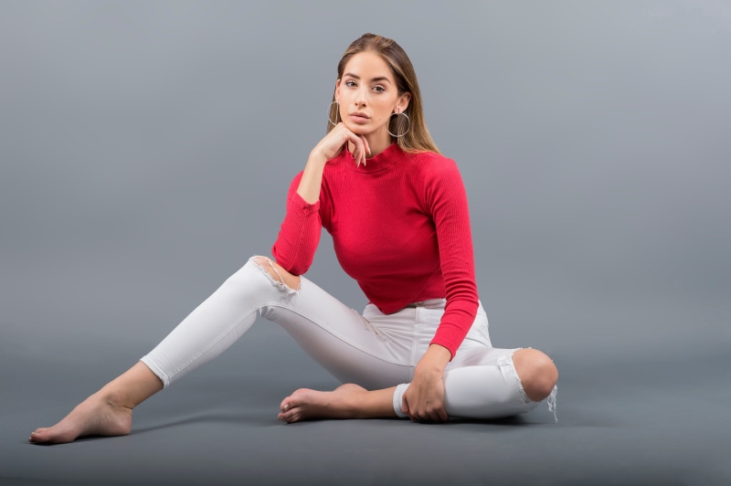 Brenda sitting on gray background