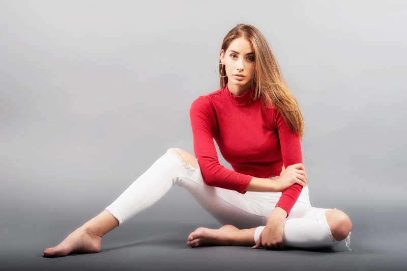 Brenda sitting on gray background