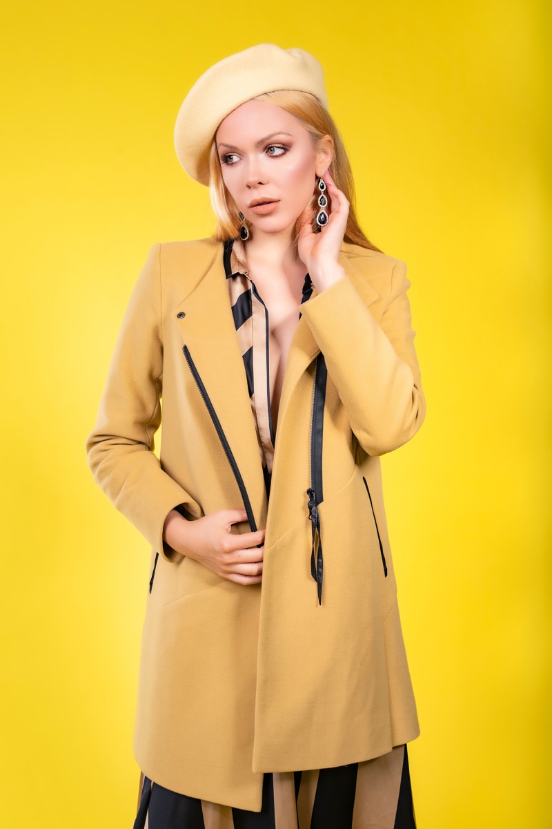 Olga-Maria Veide wearing a coat and beret
