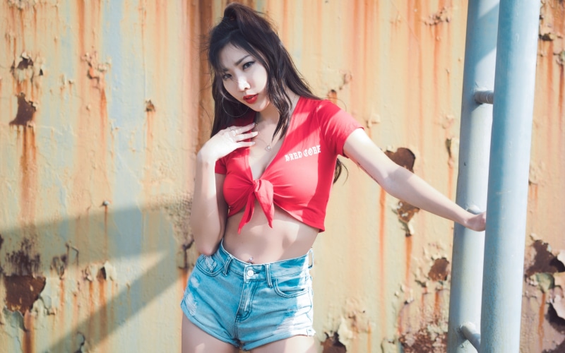 Asian girl in red top and denim shorts