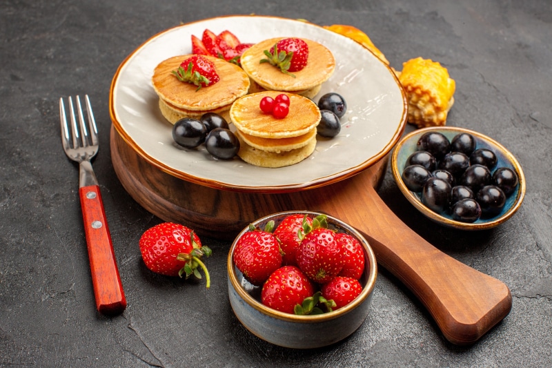 Pancakes with Strawberries and Grapes on a Plate