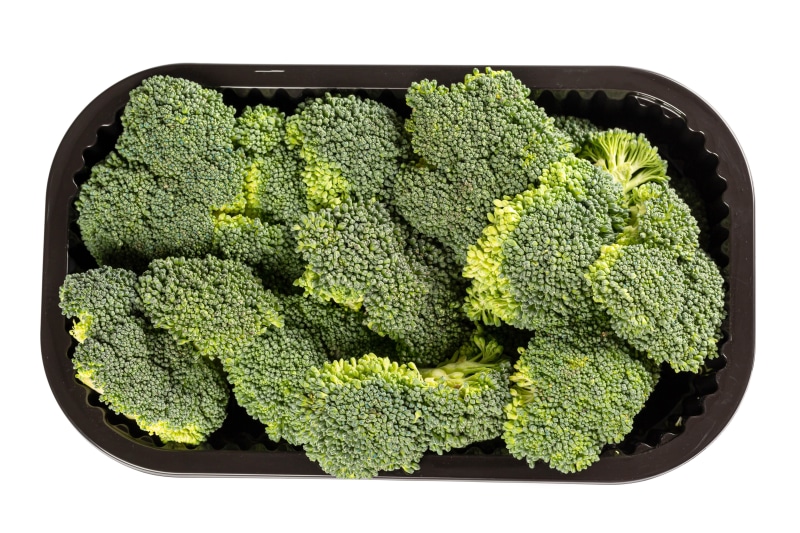 Broccoli florets in a black plastic container