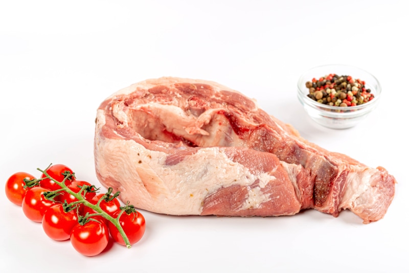 Raw pork loin with cherry tomatoes and peppercorns
